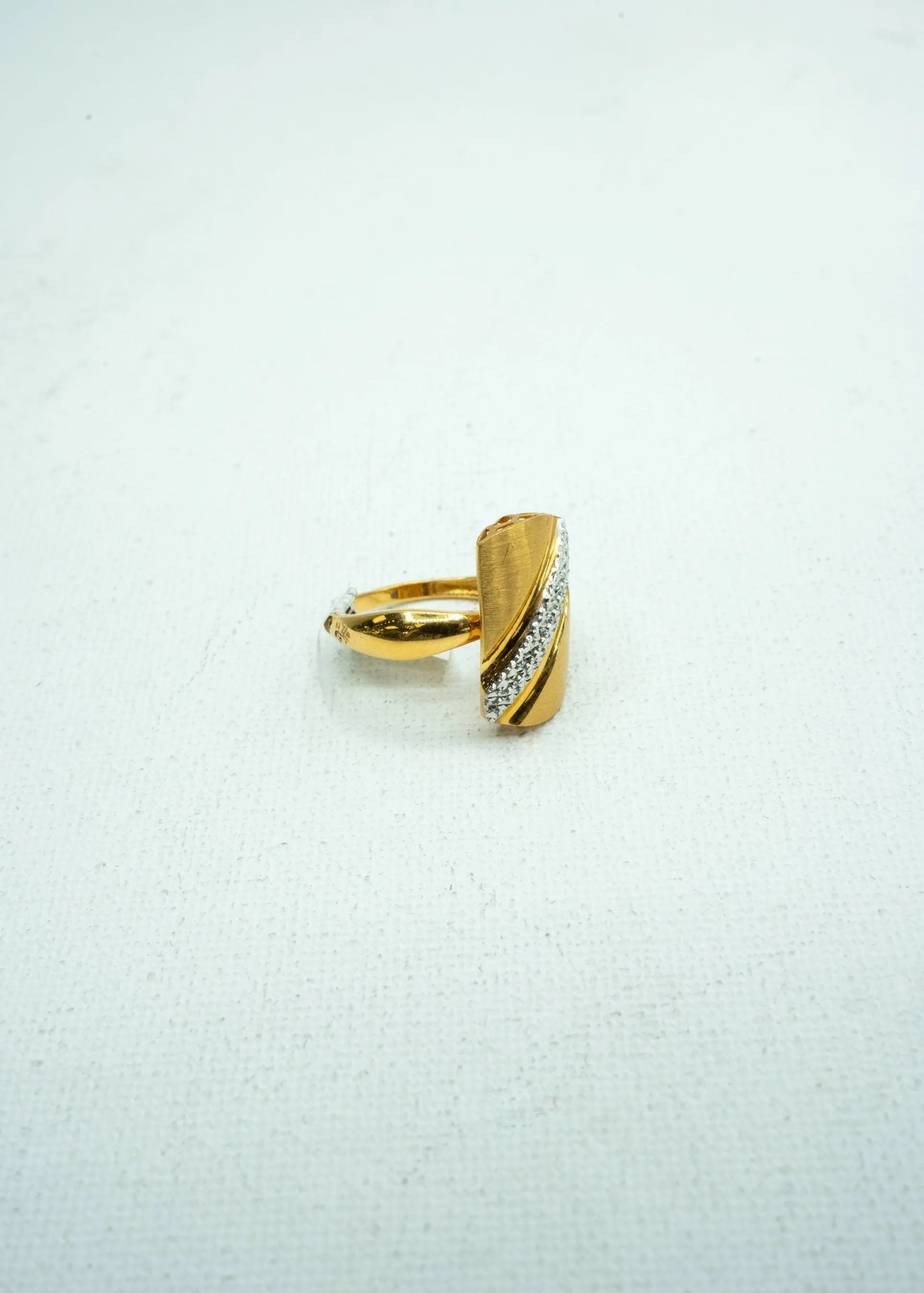 Gold Ring with diamond diagonally encrusted on it