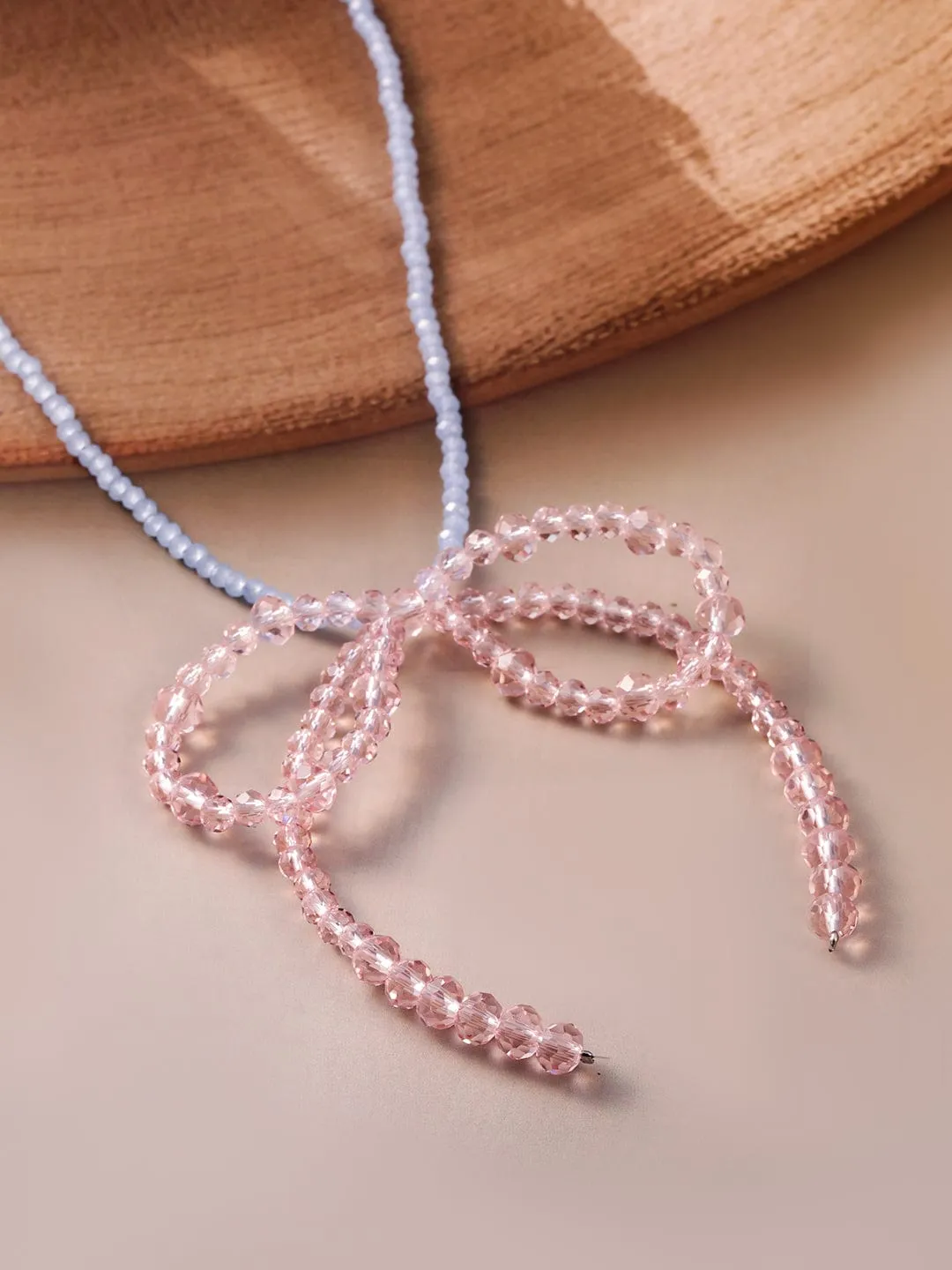 Rubans Rhodium Plated Blue Beaded Necklace with Pink Crystal Bow Pendant