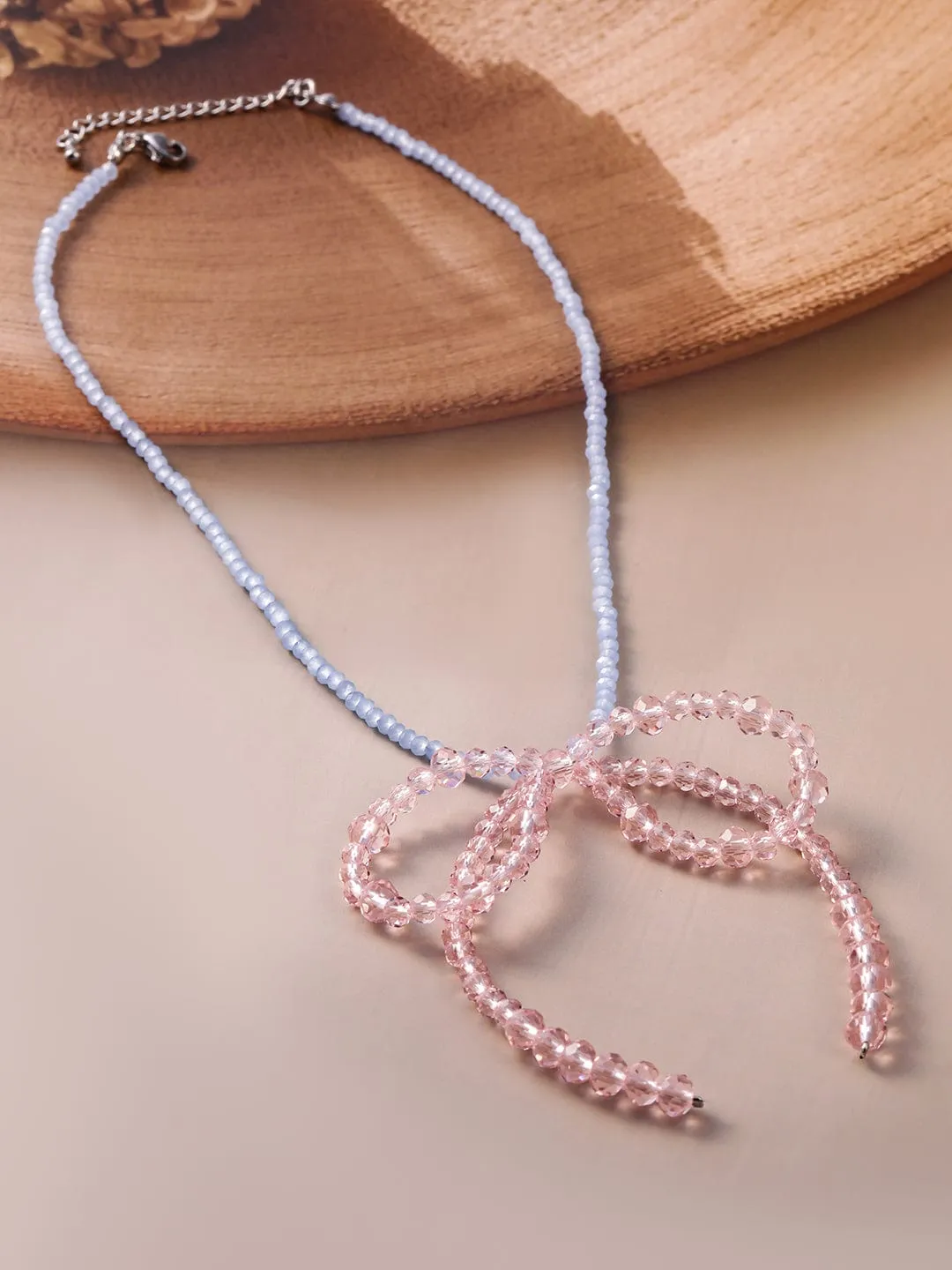 Rubans Rhodium Plated Blue Beaded Necklace with Pink Crystal Bow Pendant